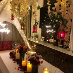We transform any space, even a cozy corner at home, into a romantic escape. This candlelight dinner setting includes a canopy of hanging flowers and fairy lights, creating a magical and intimate atmosphere for a special birthday.