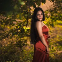 From the same outdoor series, playing with the lush green background. I focused the light to highlight the subject, making her stand out from the natural environment.