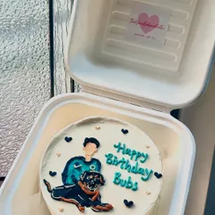 A birthday bento cake featuring a custom portrait of the birthday boy with his beloved dog. We take pride in capturing the likeness and love in these special relationships.