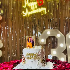 Celebrating 30 years of love with this special anniversary cake. It features an edible photo frame, golden butterflies, and delicate details, all set against a backdrop of romantic rose petals.