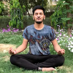 A practitioner meditating outdoors, surrounded by nature. The techniques I teach can be practiced anywhere to help you find a center of calm amidst daily life.