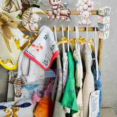 A close-up of our adorable baby shower hamper, designed as a mini wardrobe. It's filled with clothes, toys, and essentials for the new arrival.