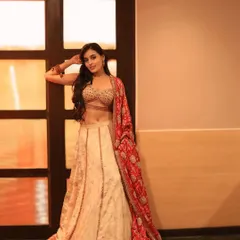 A full-length shot from the photoshoot, showcasing a modern ghagra choli. The makeup is designed to be versatile for both traditional and contemporary looks.