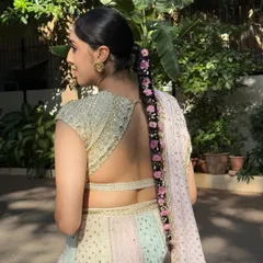 A detailed shot of the stunning floral braid I created for her Haldi. The pink flowers woven through the hair add a delicate and traditional touch.