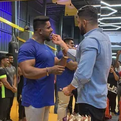 A moment of celebration with my uncle at the gym. The bond we share is the foundation of the community we've built at Kitty's Muscle Planet.