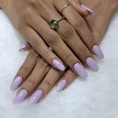 A simple and serene look featuring a solid soft lavender color on medium-length almond nails. This pastel shade is chic, calming, and effortlessly stylish.