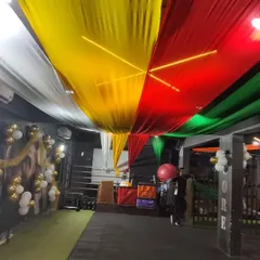 This is a wider view of the gym transformation for the Dandiya festival night. The combination of fabric ceiling decor and simple balloon arrangements creates a big impact for corporate or community events.