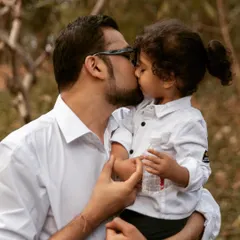 A father's gentle kiss is a quiet promise of love and protection. I believe these vulnerable, authentic moments with our children become the most priceless memories when they are captured forever.