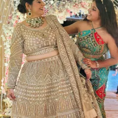 A candid moment of joy. Our client shares a laugh, looking absolutely stunning in her rented lehenga and jewellery.