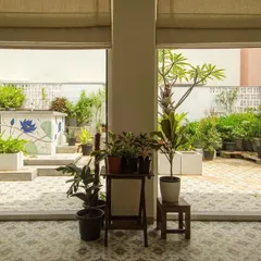A view from the inside looking out to the terrace garden. The large sliding doors dissolve the boundary between the living space and the outdoors, making the garden an extension of the home.