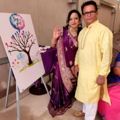 The grandparents-to-be happily posing by the gender reveal voting tree. These interactive elements create wonderful photo opportunities and lasting memories for the whole family.