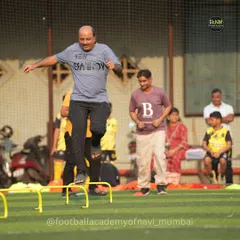 A father participates in agility drills alongside the kids. We believe parents are the biggest cheerleaders, and it's inspiring to see them lead by example on the field.