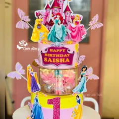This princess castle cake was designed for Saisha's first birthday. It's a rotating, multi-tier cake featuring beloved princesses, edible butterflies, and a sparkling number '1' to mark the special milestone.