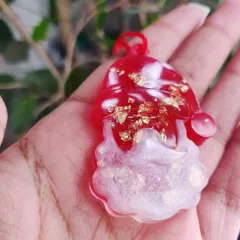 A cute Santa Claus charm made from red and white resin with gold flakes. These make great Christmas tree ornaments or festive keychain charms.