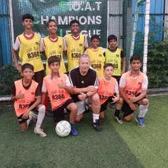 Khush Modi with his coach and teammates, a snapshot of the supportive environment that helped him succeed.