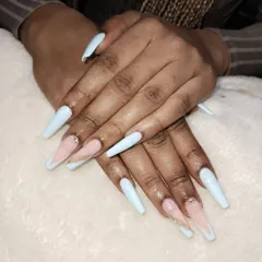 A modern and chic design on long, coffin-shaped acrylic extensions. This style combines a soft baby blue with a nude V-cut French tip, accented with a single rhinestone for a touch of sparkle.