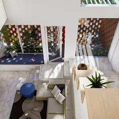 An aerial view of a double-height living space designed to feel expansive and intimate at the same time. This open-well atrium design is one of my key strategies for flooding homes with natural light and creating visual connections between floors.