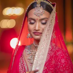 A bridal portrait is a moment of quiet reflection before a new beginning. I used the soft, ambient light to highlight her serene expression and the stunning details of her red bridal lehenga, creating a timeless, artistic photograph she will cherish forever.
