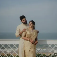 A happy couple on their wedding day. The bride's golden silk saree was pre-pleated by me to ensure it draped elegantly and moved with her, creating a beautiful silhouette against the seaside backdrop.