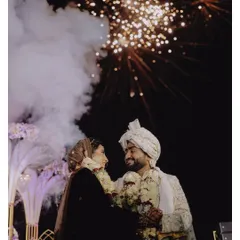A magical end to the wedding ceremony. This shot captures the couple under a sky full of fireworks, a perfect cinematic moment that encapsulates the grandeur and romance of a destination wedding in Goa.
