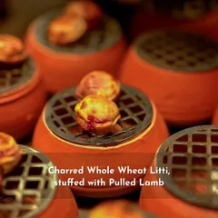 My take on a Bihari specialty: charred whole wheat litti stuffed with pulled lamb. The rustic presentation in individual terracotta pots with small grills on top keeps them warm and adds to the authenticity.
