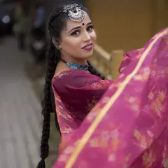 A lovely candid-style shot that captures the essence of this fusion look. The side-swept braid and statement maang tikka create a youthful and trendy vibe.