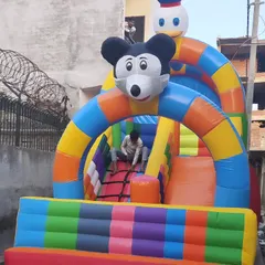 This is our 10x16 foot 2-slider bouncy, a great compact option that still offers multiple slides. It includes a climbing net and a fun Mickey and Donald character theme.