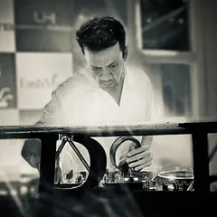 Lost in the music, finding the perfect next track. This black and white shot captures the intense focus it takes to curate a great live set.