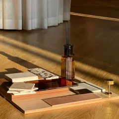 Mood boards are a glimpse into the bigger picture. This composition of wood, stone, and textile swatches, bathed in sunlight, captures the intended atmosphere of a space long before it is built.