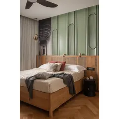 For this guest bedroom, we designed a bed with a natural oak frame and a woven cane headboard. The serene look is enhanced by a pastel green paneled wall with inset arches, creating a calm and welcoming space for visitors.