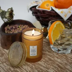 Our Bombay Orange Bourbon candle, set amongst fresh oranges and pistachios. The fragrance is a rich blend of citrus and warmth, perfect for creating a cozy and welcoming atmosphere.
