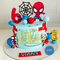 A bright and colorful Spider-Man cake with fun character toppers and balloon accents.