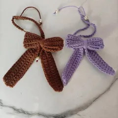 Another view of the lavender and cocoa crochet bows. They are perfect for tying in hair, decorating bags, or even for gift wrapping.