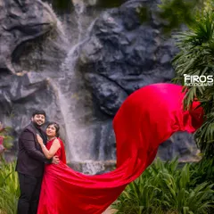 A vibrant red dress flows in the wind in front of our man-made waterfall, creating a stunning contrast between the fabric and the rocky, natural-looking backdrop.