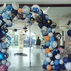 Blast off into an out-of-this-world celebration with our space-themed party decor. This setup for Darpan's space excursion features a massive balloon arch with planet and astronaut balloons, creating an immersive entrance for all the little explorers.