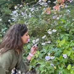 Pausing to smell the flowers. It's a simple act of mindfulness that helps you connect to the present moment and appreciate the small beauties in life.