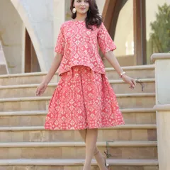 This co-ord set in a lovely coral pink features a geometric Bagru print. The top has a 20-inch length and the skirt is 25 inches long, creating a balanced look.