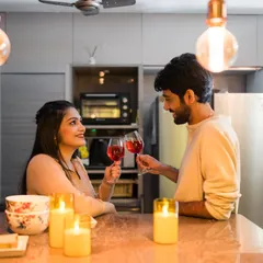 A toast to their future, surrounded by the warm glow of candles in their own kitchen. At-home shoots are incredibly personal and meaningful.