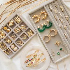 Upgrade your look with these must-have pieces. This flatlay showcases some of my favourite chunky rings, twisted hoops, and colourful cuff bangles.