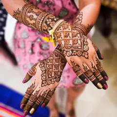 A beautiful bridal design with a focus on clean lines and varied patterns. The back of the hand features a delicate floral vine, while the arms are adorned with bands of traditional Indian motifs.