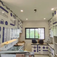 A wide view of the U-shaped kitchen during installation. Our team works carefully to assemble the factory-finished modules on-site, ensuring a perfect fit and finish.