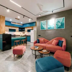 This project shows how I love to play with color to reflect a client's personality. By combining a custom blush sofa with bold teal kitchen cabinetry and polished concrete floors, we created an apartment that is modern, vibrant, and full of character.
