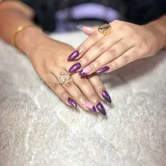 A dramatic purple cat-eye effect with a negative space accent nail. The shimmer and depth in these nails are incredible.