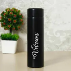 This is a clean shot of the black insulated steel flask, personalized with the name "Varun" in a stylish script font. It's a sleek and useful accessory for keeping drinks hot or cold.