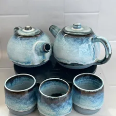A pair of teapots with matching cups. I often make pieces in small batches, and it's lovely to see them together before they go to their new homes.
