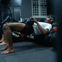 Building the posterior chain with weighted hip thrusts. A strong back, glutes, and hamstrings are the engine for all powerful movements in combat sports.