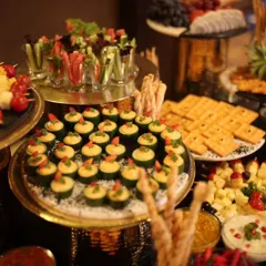 It's all about the details. This is a spread of my gourmet canapés, including cucumber cups with hummus and vegetable crudités in shot glasses. Each bite is designed to be a burst of flavour and a feast for the eyes.