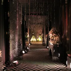 We believe the guest experience begins at the entrance. For this glamorous black and silver themed Sangeet, we designed a dramatic entryway with a chevron-patterned floor and shimmering crystal curtains, setting the stage for an unforgettable night of music and celebration.