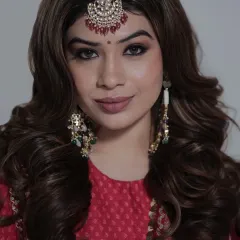A striking beauty portrait captured in our studio. The focus is on the model's expressive eyes and flawless makeup, highlighted by the traditional maang tikka. This showcases our expertise in close-up portraiture.