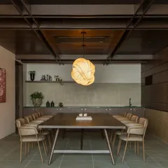 Within the larger auditorium project, we created this intimate VIP lounge design. It serves as a quiet, refined retreat for meetings or private conversations, featuring a custom conference table, sophisticated lighting, and rich wood textures for a cozy, exclusive feel.